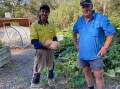 Noel Hocking (right) farewelling the large butternut pumpkins that he has been carefully growing. Happy to accept them is Darryn Kopp. Image supplied