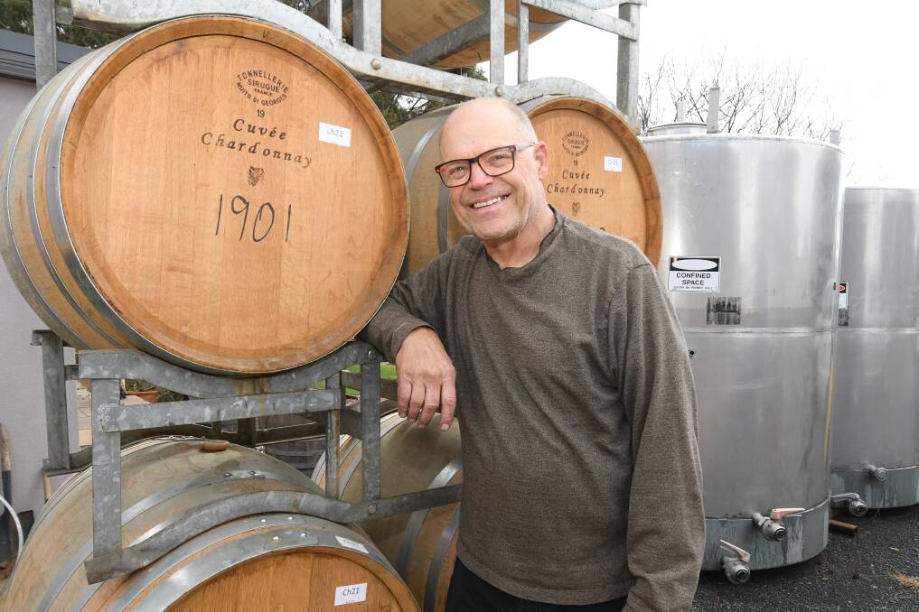 Owner of Orange's Patina Wines, Gerald Naef with his trusty oak barrels as local wine legend shortlisted in 2023 Halliday Wine Companion Winemaker of the Year. Picture by Jude Keogh.