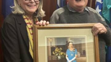 Forbes Mayor Phyllis Miller OAM presents the portrait to Bruce Adams from Forbes Museum. Picture Forbes Shire Council