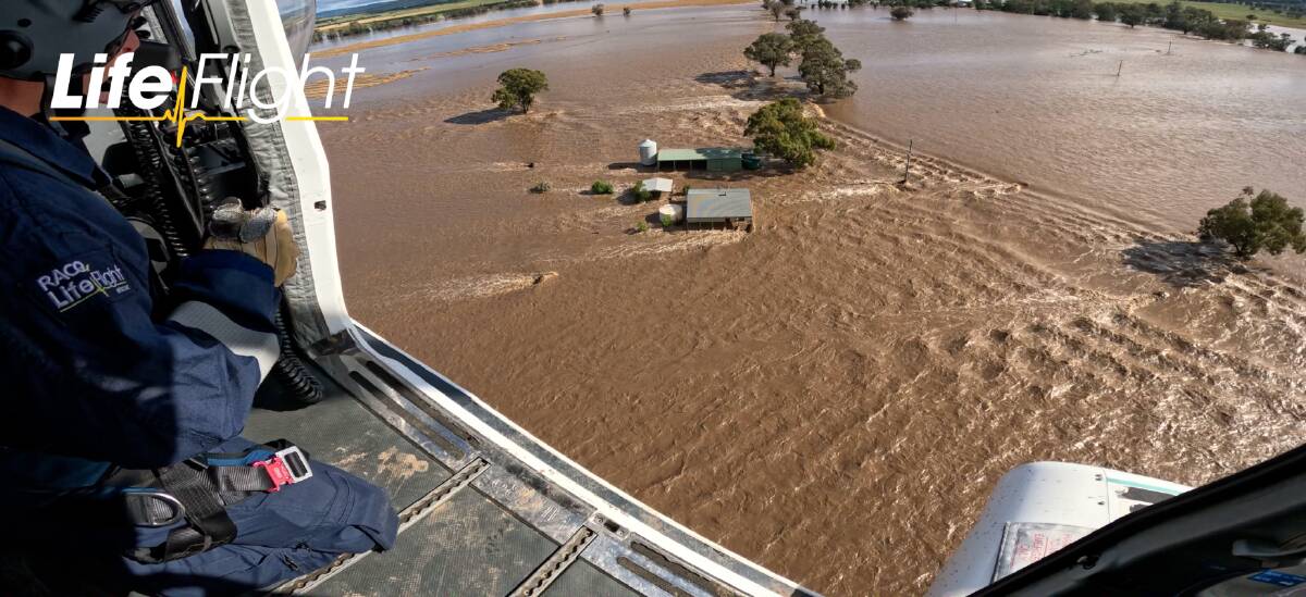 The force of the water rushing around Kim Storey's home is evident in this aerial image. Picture by Life Flight