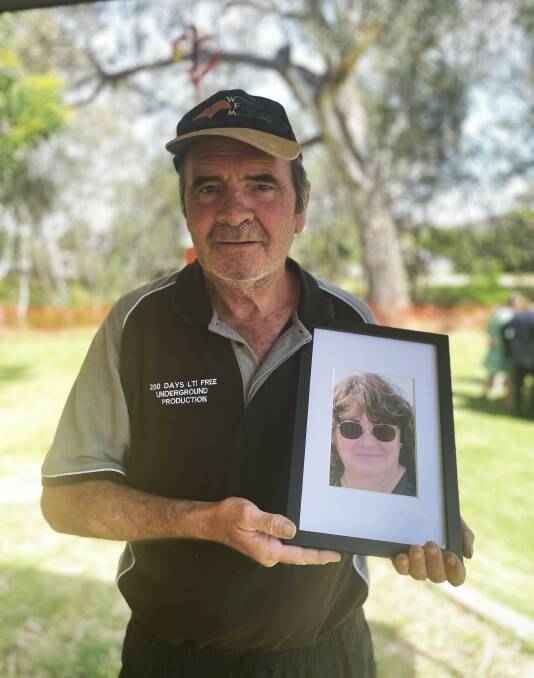 Tim Townsend with a photo of his late sister Diane Smith. 