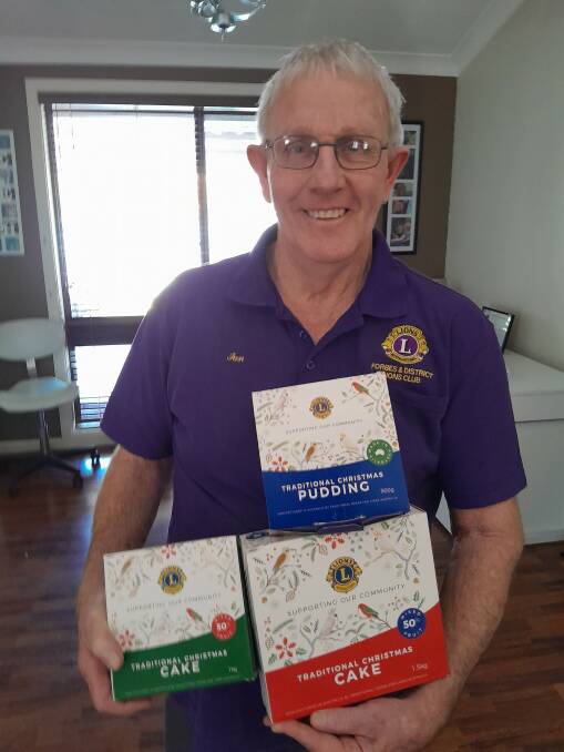 Lion Ian Acret with the Christmas cakes and puddings now on sale in Forbes and Parkes. Picture supplied