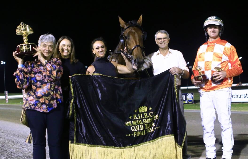 Denise and Phil Thurston, their daughters Jacinta Grogan and Haylee Redfern, and trainer driver Brad Hewitt celebrating Bittersweet's win. Picture by Coffee Photography