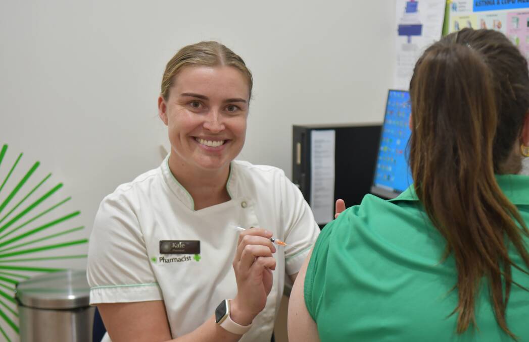 Pharmacist Kate French prepares to administer a vaccine at Flannery's in Forbes.