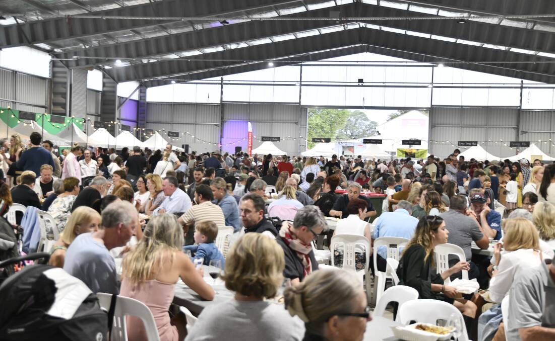 People flocked to the Naylor Pavilion at Orange Showground that was set up as a wet-weather alternative for the Orange FOOD Week Night Market on Friday. Picture by Carla Freedman