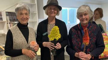 Denise Thurston, Irene Ford and Marie Langfield showing their prize winning entries in Flower of the month.