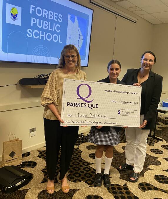 QUE president Kath Whitchurch presents Forbes Public School vice captain Milly Ridley and principal Meg Staples with the generous donation from Thuringowa Quota Club. Photo supplied